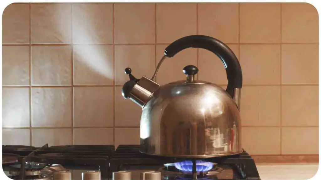 a silver kettle sitting on top of a stove