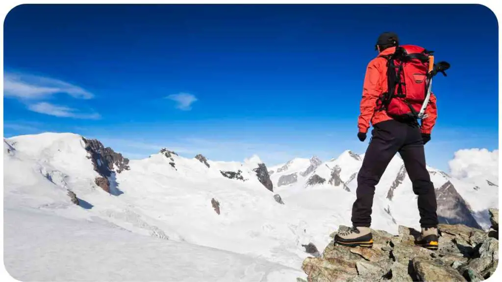 a person with a backpack standing on top of a mountain