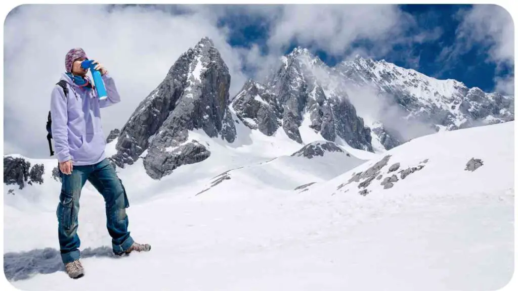 a person standing on top of a snow covered mountain