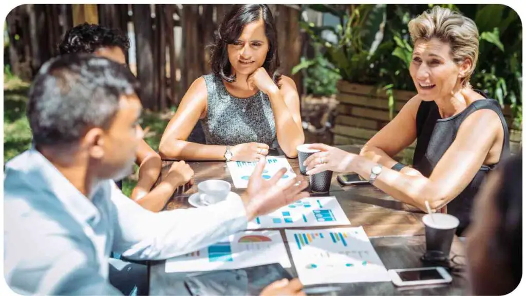 a group of people sitting around a table with papers